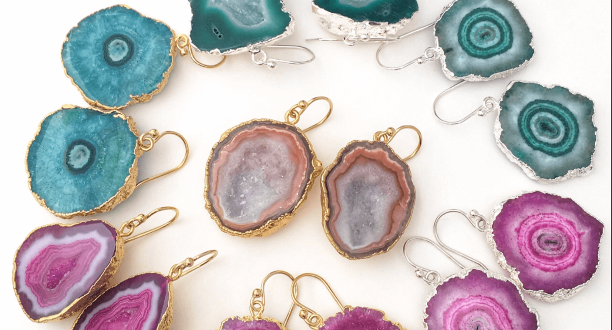 Turquoise, purple, and pink geode earrings arranged in a circle